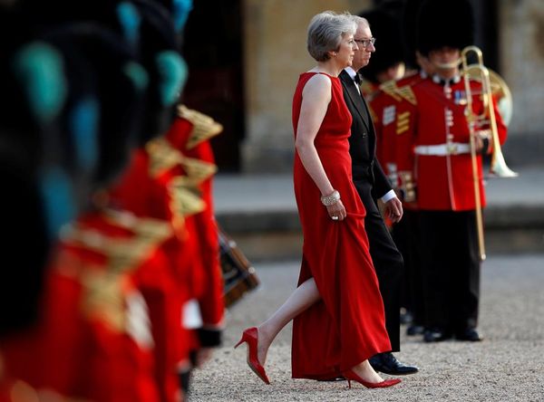 PM May and her husband Phillip walk out to meet Pr...