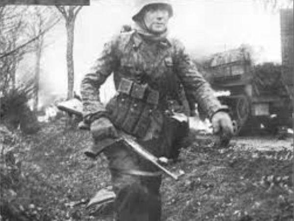 SS soldiier with StG44 retreating in the Ardennes,...
