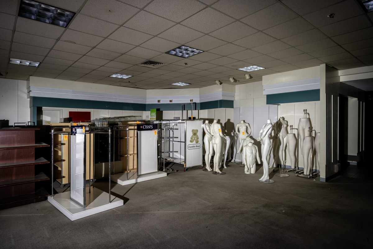 Headless mannequins amid empty shelves and sales d...